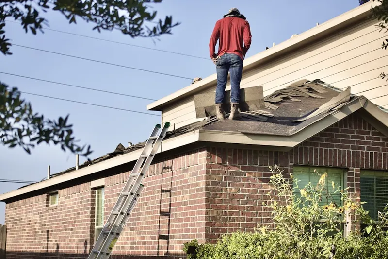 Professional roofer working on a residential roof in Mission Hills